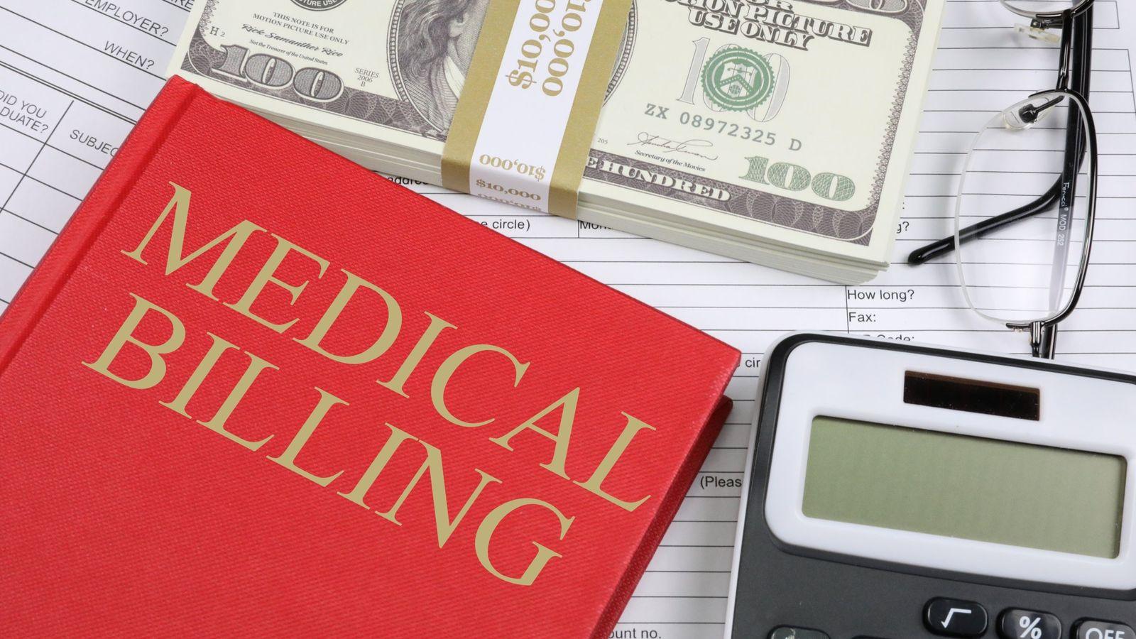 Medical billing paperwork with calculator and documents