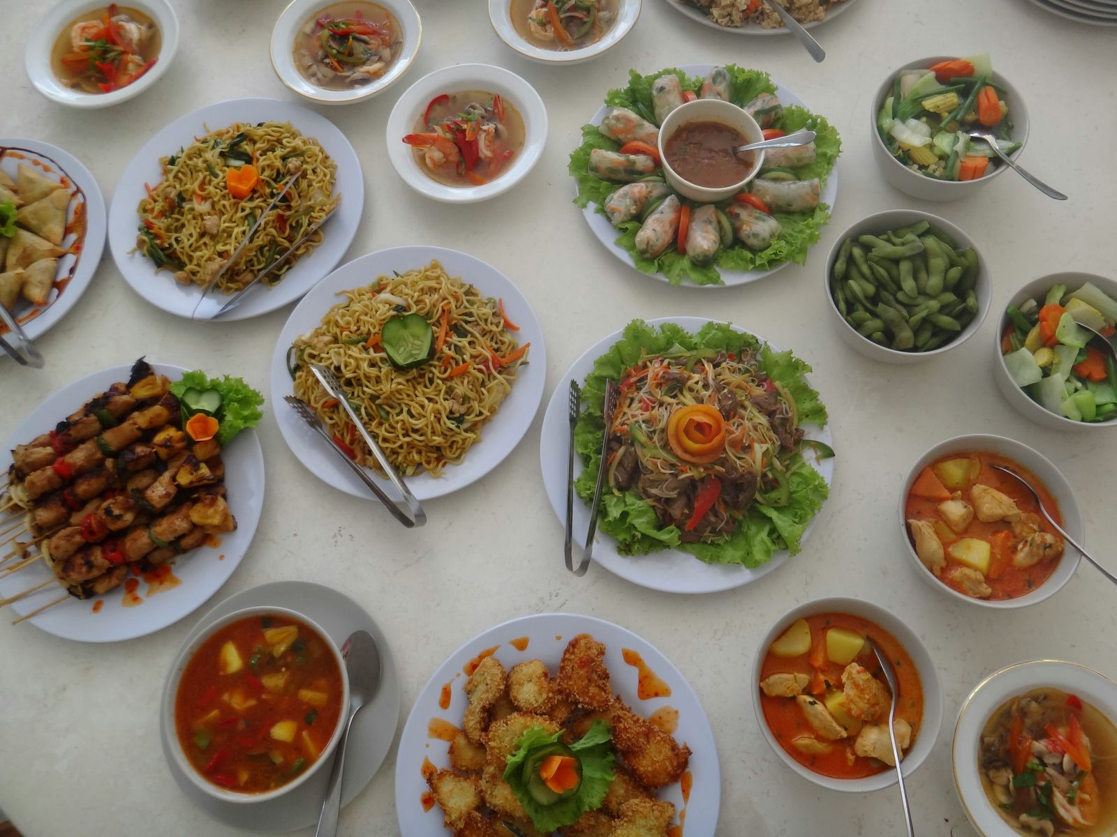 A table of Indonesian dishes served with rice and vegetables