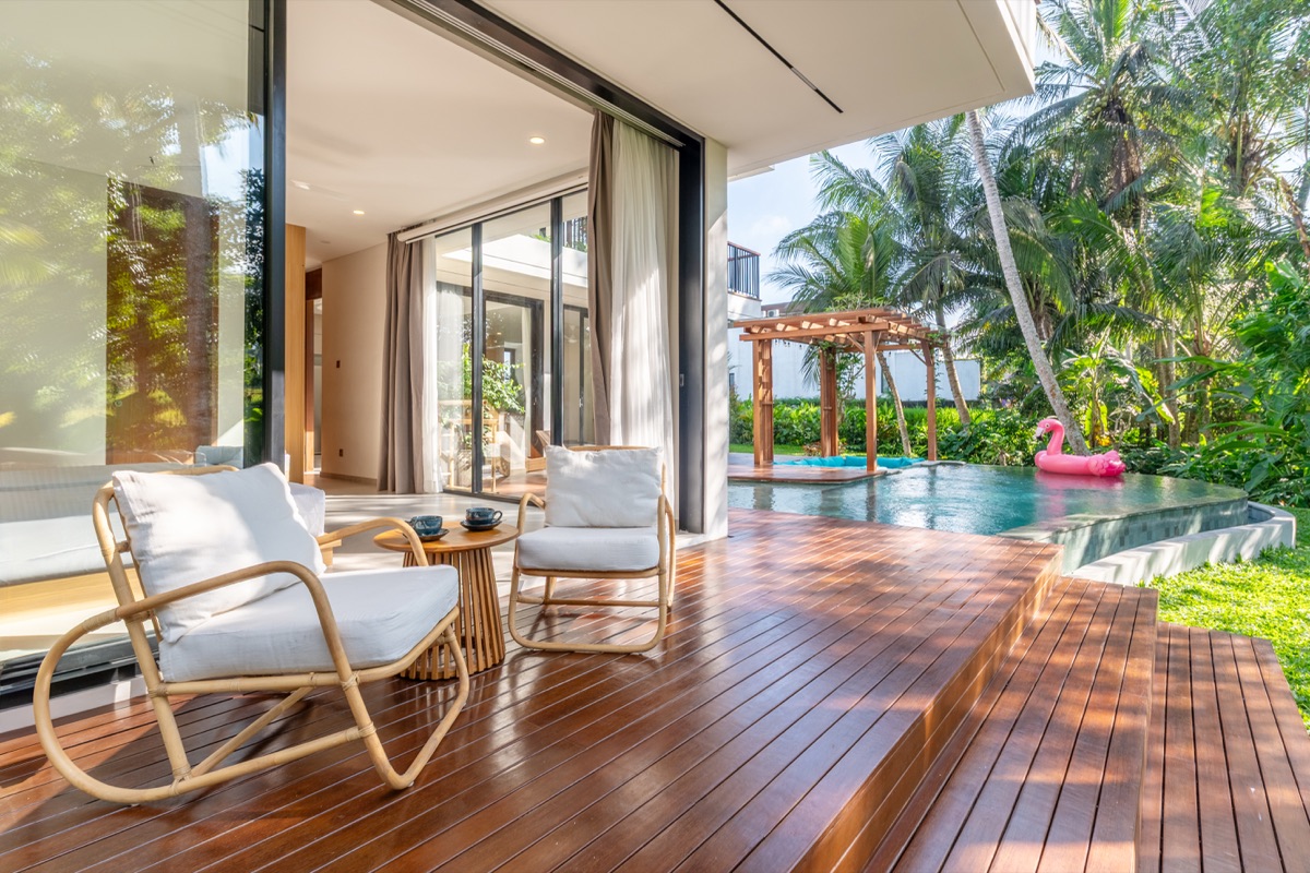Terrace deck with rattan chairs and private pool at Hubuddha Three Bedroom Villa Ubud Bali