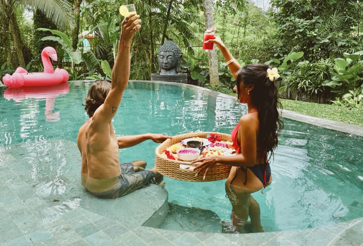 Couple enjoying private pool with floating breakfast at Hubuddha Three Bedroom Villa Ubud Bali