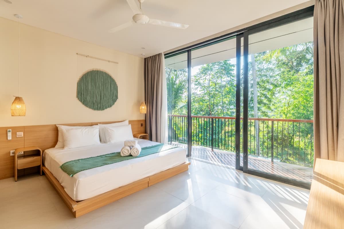Second bedroom with queen bed and jungle balcony at Hubuddha Three Bedroom Villa Ubud Bali