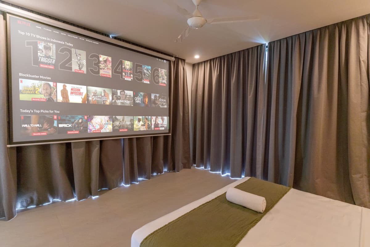 Master bedroom with large projector screen for cinema experience at Hubuddha Three Bedroom Villa Ubud Bali