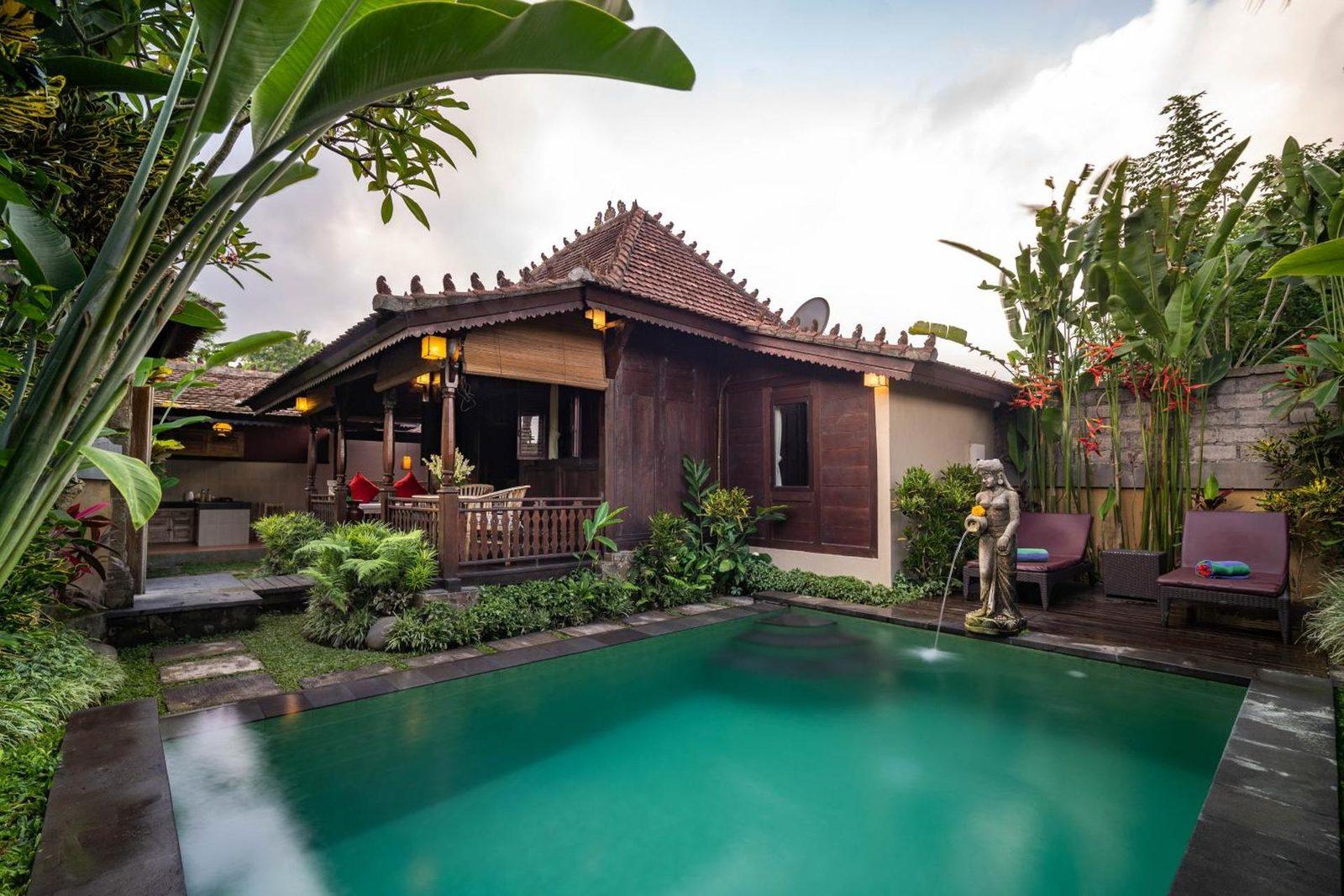 Private pool and Balinese pavilion framed by lush greenery at Villa Nini, Kedewatan, Ubud