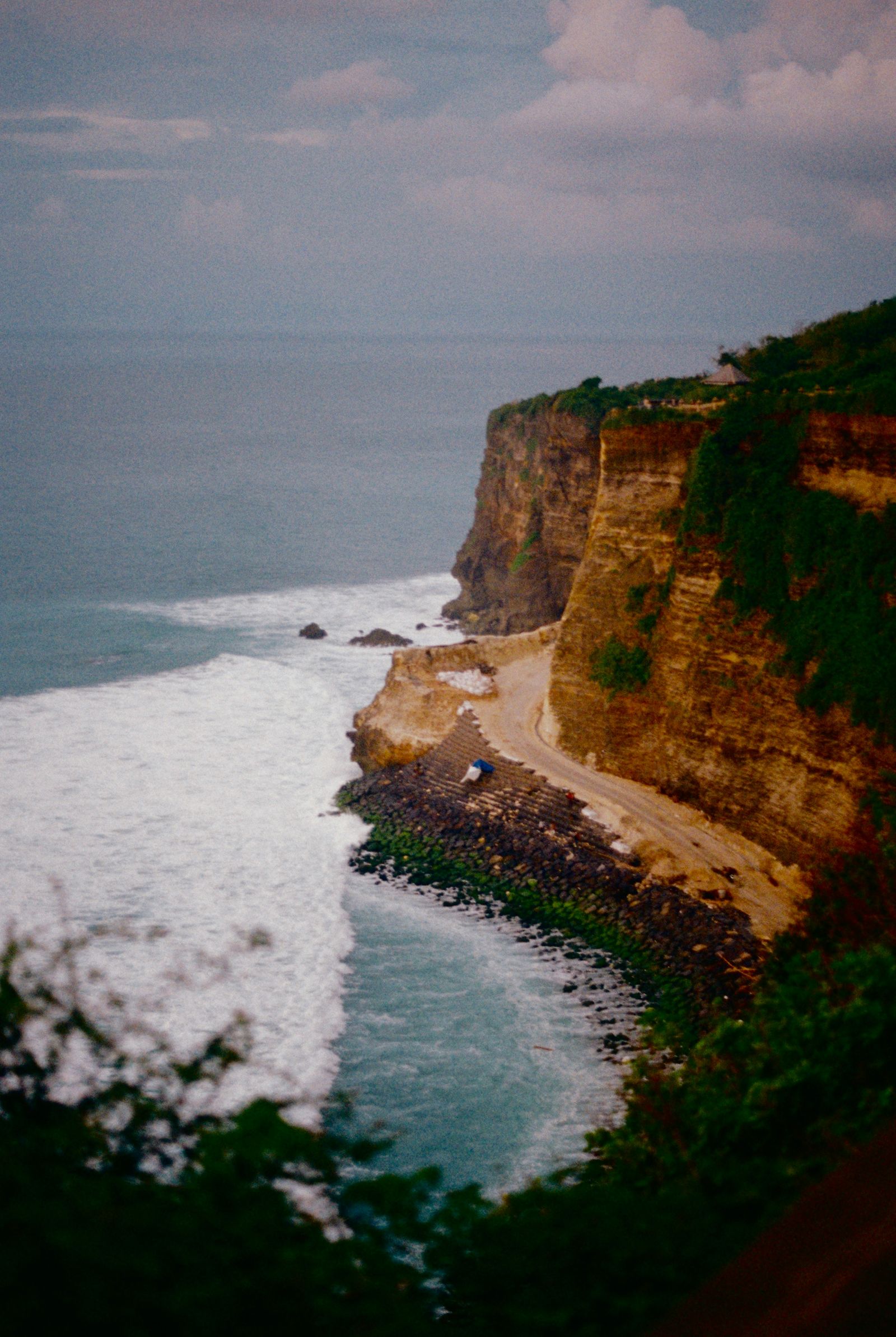 A coastal road beside cliffs and ocean in Bali