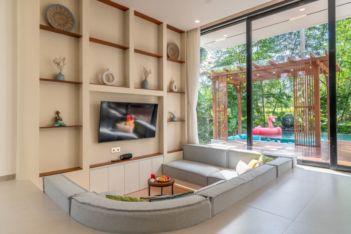 Sunken living room with circular sofa and pool view at Hubuddha Three Bedroom Villa Ubud Bali