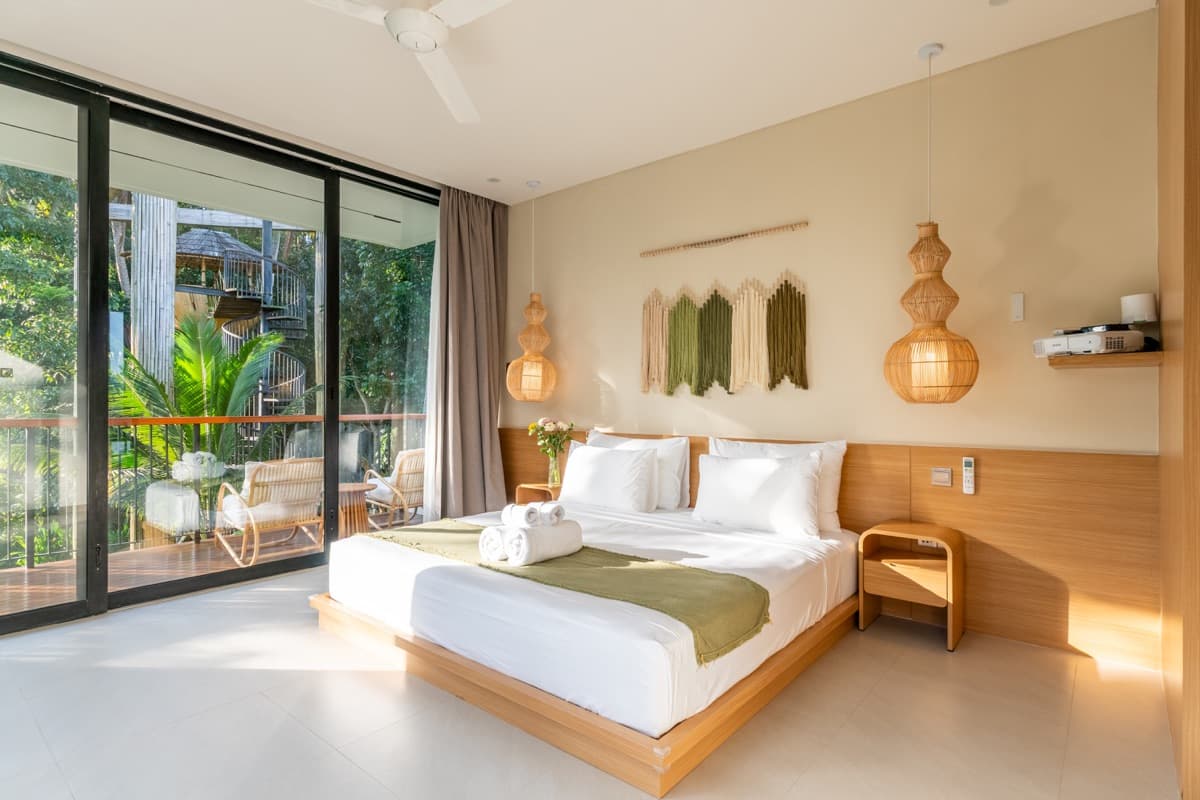 Master bedroom with garden balcony and spiral staircase view at Hubuddha Three Bedroom Villa Ubud Bali